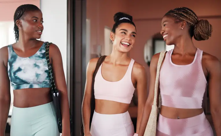 three women wearing workout clothes